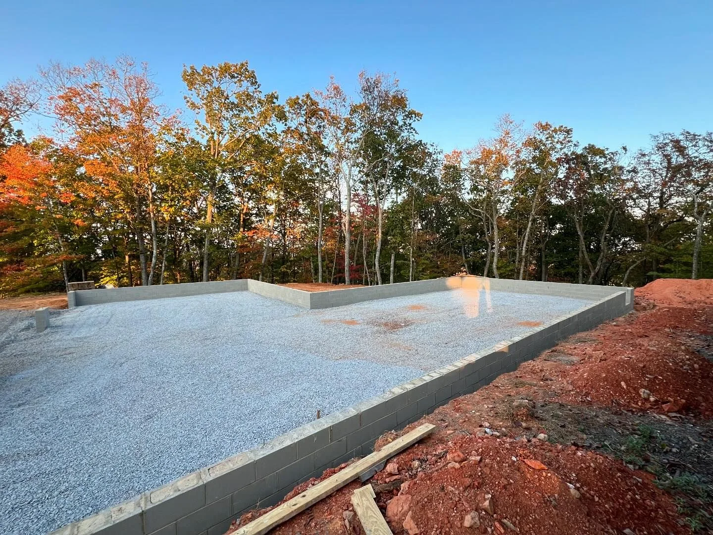 Prepared building base surrounded by autumn trees