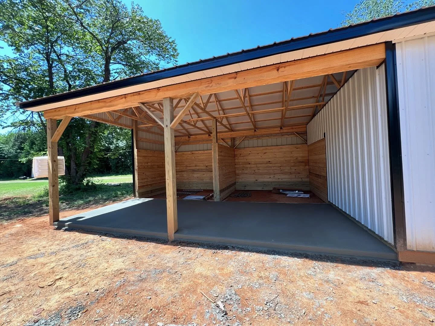 Concrete floor under a timber-framed shelter