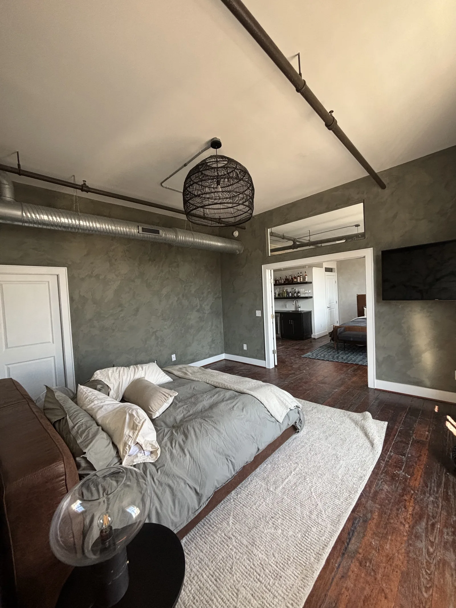 Finished grey textured wall in a furnished bedroom